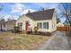 Yellow home with black shutters, a red front door, and a paved driveway at 1711 Kessler E Blvd, Indianapolis, IN 46220