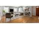 Bright staged living room featuring wood floors, neutral colors, and ample natural light at 1711 Kessler E Blvd, Indianapolis, IN 46220