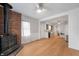 Bright, open-concept living room with a brick fireplace, modern kitchen, and light-toned hardwood floors at 1711 Kessler E Blvd, Indianapolis, IN 46220