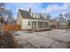 View of the charming yellow home with a screened-in porch and spacious backyard area at 1711 Kessler E Blvd, Indianapolis, IN 46220