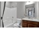 A well-lit bathroom features a shower-tub combo, toilet, and a vanity with a dark wood cabinet at 181 Cline St, Westfield, IN 46074