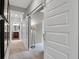 Hallway leads to a bright bathroom and a cozy seating area, showcasing sliding barn doors and stylish decor at 181 Cline St, Westfield, IN 46074