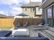 A backyard area with modern outdoor furniture on a wooden deck with a fenced in yard at 1838 Alabama St, Indianapolis, IN 46202