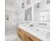 Modern bathroom featuring double sinks, a glass-enclosed shower with stylish tile work at 1838 Alabama St, Indianapolis, IN 46202