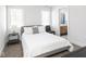 Bright bedroom with a gray platform bed, large windows, and ensuite access at 1838 Alabama St, Indianapolis, IN 46202