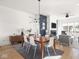 A modern dining area boasts a dark blue accent wall, a fireplace, and sleek wooden floors at 1838 Alabama St, Indianapolis, IN 46202