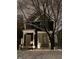 Charming home exterior features a covered porch, snow covered yard, and string lights for holiday cheer at 1838 Alabama St, Indianapolis, IN 46202
