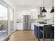 A modern kitchen featuring an island with bar seating and sliding glass doors to an outdoor area at 1838 Alabama St, Indianapolis, IN 46202