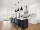 A modern kitchen boasts white cabinetry, a kitchen island, and sliding doors to the outdoors at 1838 Alabama St, Indianapolis, IN 46202