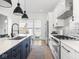 Modern kitchen with an island with a sink and marble countertop, adjacent to stainless steel appliances at 1838 Alabama St, Indianapolis, IN 46202
