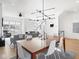 Open concept shows living room and dining room with sleek light fixture and stairs at 1838 Alabama St, Indianapolis, IN 46202