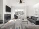 Spacious living room with a fireplace, modern decor, and abundant natural light at 1838 Alabama St, Indianapolis, IN 46202