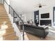 Bright living space with stairs, hardwood floors, fireplace, and comfortable seating at 1838 Alabama St, Indianapolis, IN 46202
