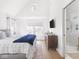 Airy primary bedroom with ensuite access, modern TV and clerestory window at 1838 Alabama St, Indianapolis, IN 46202