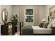 Inviting bedroom with a large window, dark wood furnishings, and soft textures, offering a peaceful retreat at 19574 Boulder Brook Ln, Westfield, IN 46074