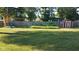 A spacious yard featuring a playset, swing set, and garden area provides many options for activities at 204 W Pullman St, Waldron, IN 46182