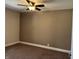 Bedroom featuring neutral carpet, ceiling fan, and baseboard trim at 204 W Pullman St, Waldron, IN 46182