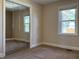 Bedroom featuring mirrored closet doors, neutral carpet, and a window at 204 W Pullman St, Waldron, IN 46182