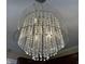 Modern chandelier featuring crystal pendants and a translucent, geometric shade at 204 W Pullman St, Waldron, IN 46182