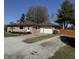 Charming single-story home with stone exterior, driveway, and mature trees at 204 W Pullman St, Waldron, IN 46182
