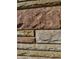 Close-up of the home's exterior featuring earth-tone stone detail at 204 W Pullman St, Waldron, IN 46182