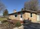 Charming home with stone facade, front deck, and professionally landscaped yard at 204 W Pullman St, Waldron, IN 46182