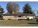 Charming single-story home with stone facade, manicured lawn, and attached garage at 204 W Pullman St, Waldron, IN 46182