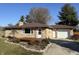 Charming single-story home featuring stone facade, front deck, and attached garage at 204 W Pullman St, Waldron, IN 46182