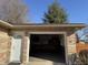 A spacious two-car garage with stone detail and a side entrance offers convenience and complements the home's exterior at 204 W Pullman St, Waldron, IN 46182