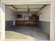 An empty garage with a neutral gray and white paint scheme offers ample space for storage at 204 W Pullman St, Waldron, IN 46182