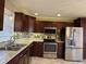 Well-equipped kitchen featuring stainless steel appliances and granite countertops at 204 W Pullman St, Waldron, IN 46182
