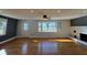 Bright living room featuring hardwood floors, fireplace, and large windows with natural light at 204 W Pullman St, Waldron, IN 46182