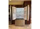 Stainless steel refrigerator showcases open shelving, bright interior lighting and a lower freezer drawer at 204 W Pullman St, Waldron, IN 46182