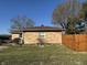 Manicured side yard with privacy fence and brick veneer at 204 W Pullman St, Waldron, IN 46182