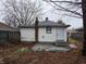 Backyard featuring a chimney, siding, and small door at 238 S Temple Ave, Indianapolis, IN 46201