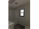 Plain bathroom with a white, built-in tub and a neutral color palette at 238 S Temple Ave, Indianapolis, IN 46201