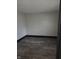 Neutral bedroom with wood laminate flooring and white walls at 238 S Temple Ave, Indianapolis, IN 46201