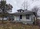 Modest home featuring gray trim on the porch and siding, under an overcast sky at 238 S Temple Ave, Indianapolis, IN 46201