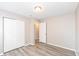 Bedroom with light gray walls, laminate floors, and closet with a view to another room at 3026 Everbloom Way, Indianapolis, IN 46217