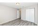 Bedroom features light gray walls, laminate wood flooring, and closet at 3026 Everbloom Way, Indianapolis, IN 46217