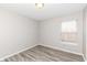 This is a bright bedroom with light grey walls and laminate flooring at 3026 Everbloom Way, Indianapolis, IN 46217