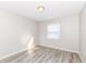 Bright bedroom featuring light gray walls and laminate wood flooring at 3026 Everbloom Way, Indianapolis, IN 46217