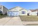 Charming single Gathering home featuring a garage, well-kept lawn, and bright, welcoming facade at 3026 Everbloom Way, Indianapolis, IN 46217