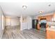 Modern kitchen with stainless steel appliances, wood cabinets and wood-look flooring at 3026 Everbloom Way, Indianapolis, IN 46217