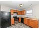 This kitchen features wooden cabinets, modern appliances, and a stainless steel oven and dishwasher at 3026 Everbloom Way, Indianapolis, IN 46217