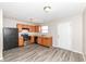 Cozy kitchen featuring modern appliances, wood cabinets, and durable wood-look flooring at 3026 Everbloom Way, Indianapolis, IN 46217