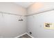 A utility room features shelving, washer and dryer hookups, and luxury vinyl plank flooring at 3026 Everbloom Way, Indianapolis, IN 46217