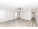 Open living room featuring wood-look floors, neutral paint and ample natural light at 3026 Everbloom Way, Indianapolis, IN 46217