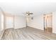 Open living room with grey wood-look floors, neutral paint and ample natural light at 3026 Everbloom Way, Indianapolis, IN 46217