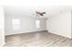 Spacious living room boasting natural light, neutral walls, and grey wood-look floors at 3026 Everbloom Way, Indianapolis, IN 46217